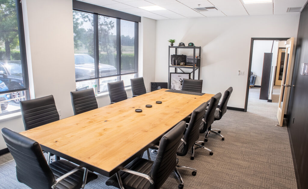 Namebrand's conference room featuring modern black and wood designs. 